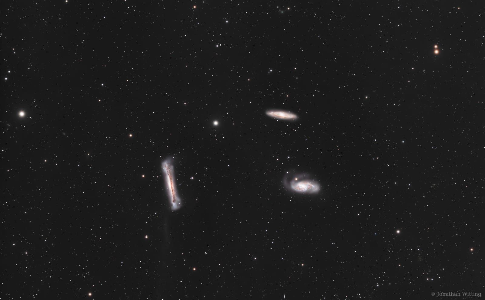 The Leo Triplet, three interacting spirals in one field, with NGC 3628 edge-on at the top.